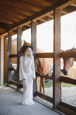 young woman in a dress with a horse.