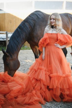 young woman in a dress with a horse.