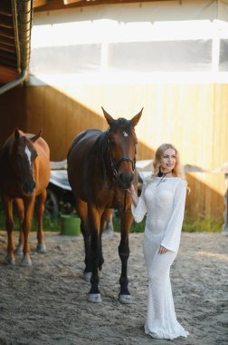 young woman in a dress with a horse.