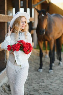 young woman in a dress with a horse.