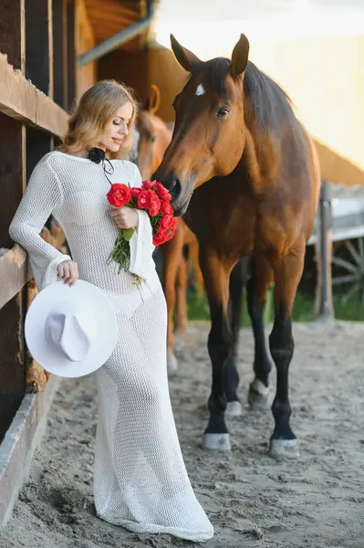 young woman in a dress with a horse.