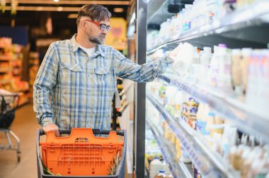 Senior man at supermarket store.