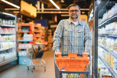 Senior man at supermarket store.