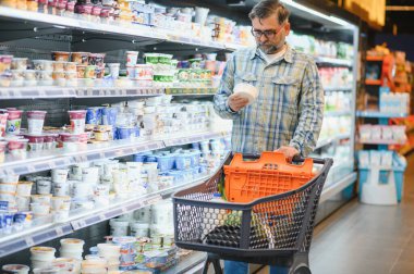 Senior man at supermarket store.