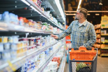 Senior man at supermarket store.