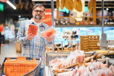 Senior man at supermarket store.