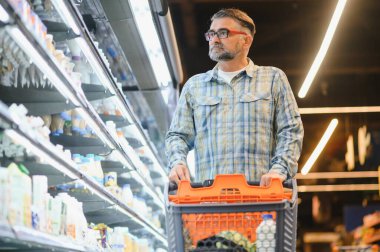 Senior man at supermarket store.