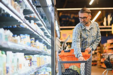 Senior man at supermarket store.