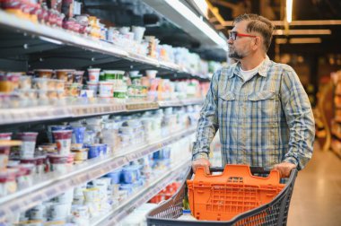 Senior man at supermarket store.
