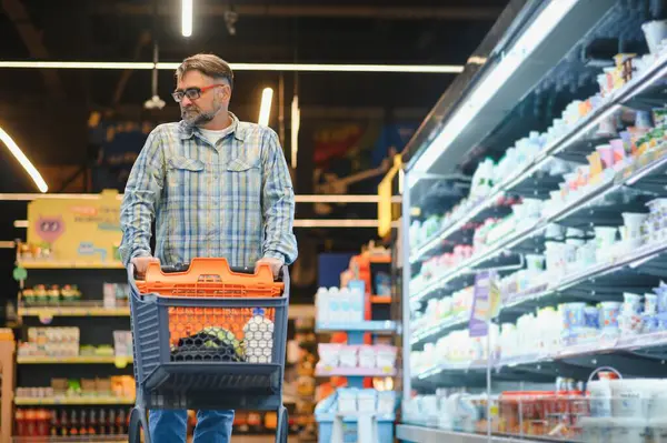 Senior man at supermarket store.