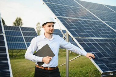 Solar power plant. Engineer on a background of photovoltaic panels. Science solar energy