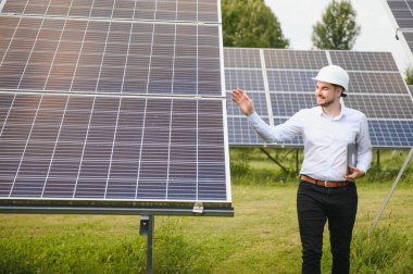 Solar power plant. Engineer on a background of photovoltaic panels. Science solar energy