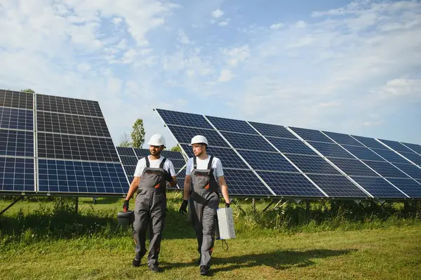 İki mühendisden oluşan bir ekip bir güneş enerjisi istasyonuna güneş panelleri kurmaya çalışıyor. Mühendis ekibi güneş pilleri kurma işini tartışıyor.