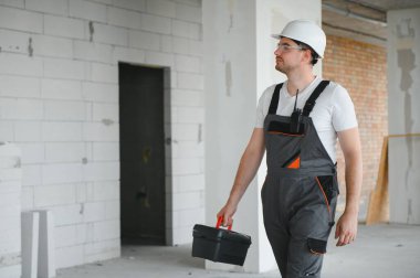 İnşaat sektöründe çalışan yakışıklı işçinin portresi.