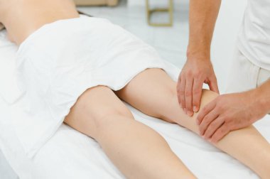 Woman getting relaxing feet massage with oils after long day.