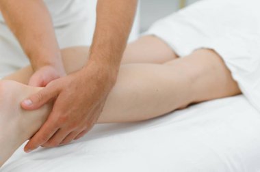 Woman getting relaxing feet massage with oils after long day.