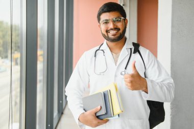 multiracial South Asian medical students with a medical court and stethoscope. medical student life. clipart