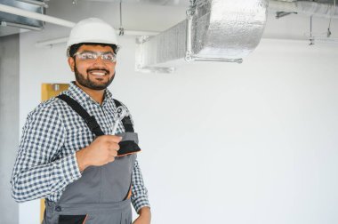 Hvac Hintli işçiler havalandırma ve havalandırma için boru sistemi kuruyor. Boşluğu kopyala.