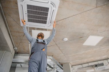 Uzman havalandırmayı tamir ediyor..