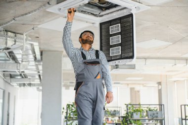 Uzman havalandırmayı tamir ediyor..