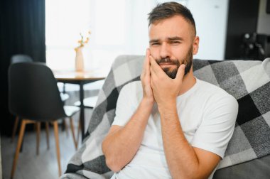 Genç adam evinde diş ağrısı çekiyor..