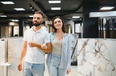Evli çift mutfak için seramik fayanslar seçiyor ya da bir hırdavatçıda banyo yapıyor..