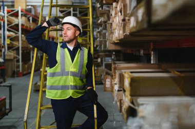 Gülümseyen bir depo çalışanının portresi. Nakitte çalışıyor ve toptan satış yapıyor..