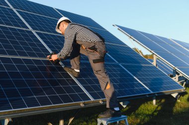 Dışarıda güneş panelleri kuran işçiler.
