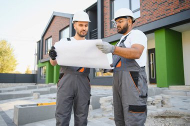 İnşaat müfettişi ve müteahhit yeni kulübe kompleksini inceliyor..