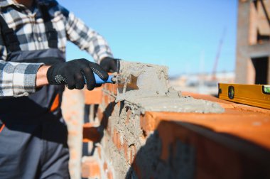 İnşaat mason işçi çimento tuğla açık havada mala macun bıçak ile yükleme.