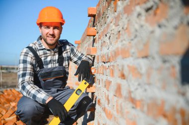 Açık havada inşaat alanında çalışan bir inşaatçının portresi..