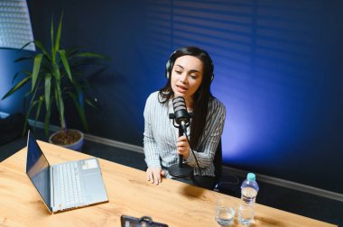 Smiling young caucasian girl woman making a video blog (vlog) with camera clipart