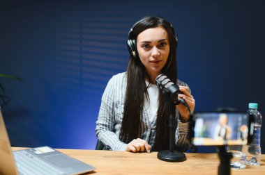 Smiling young caucasian girl woman making a video blog (vlog) with camera clipart