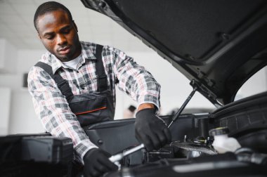 Gülümseyen araba tamircisi oto tamir servisinde.