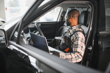 Otomobil bilgisayar teşhisi. Araba tamircisi motor arızasını arıyor.