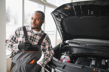 Gülümseyen araba tamircisi oto tamir servisinde.