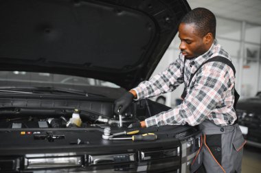 Gülümseyen araba tamircisi oto tamir servisinde.