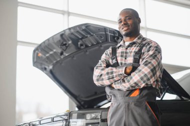 Gülümseyen araba tamircisi oto tamir servisinde.