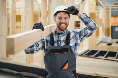 Modern modüler ev. Bir işçi ahşap bir evin inşaatında çalışıyor..