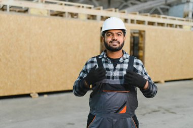 Hintli marangoz modüler evler inşaatında çalışıyor..