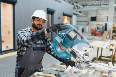 Hintli marangoz modüler evler inşaatında çalışıyor..