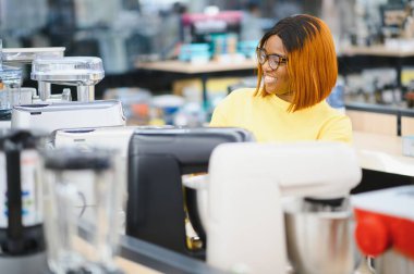 genç kadın ev aletleri alışveriş merkezi süpermarkette mutfak karıştırıcı blender seçimi.