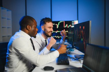 Bu başarıdır. Ofiste kazanan anlaşmayı kutlayan iki mutlu tüccar ya da mali analist var..