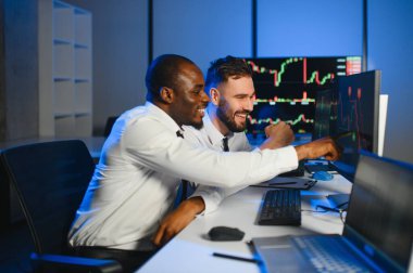 Takım çalışması kavramı. Borsacılardan oluşan bir ekip modern ofiste birçok ekran ekranı ile çalışır..