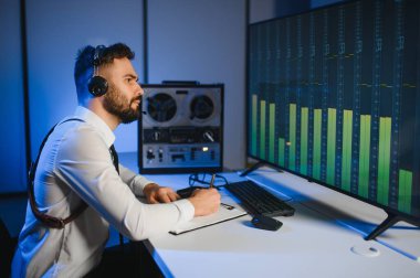 Gizli ajan kayıt cihazını dinliyormuş. Memur kulaklıkla dinleme yapıyor..