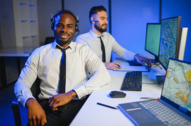 Tamirat merkezi. Seyrüsefer kontrol panosunda otururken mikrofonla çalışan erkeklerin portresi.
