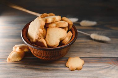 Tahta arka planda izole edilmiş tereyağlı kurabiyeler..