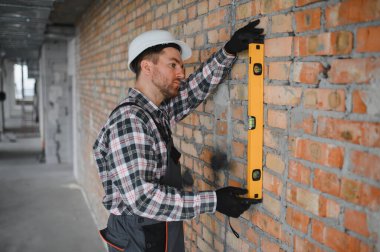 Bir inşaat veya yenileme projesi sırasında bir tuğla duvarın mükemmel bir şekilde dikey hizalanmasını sağlar
