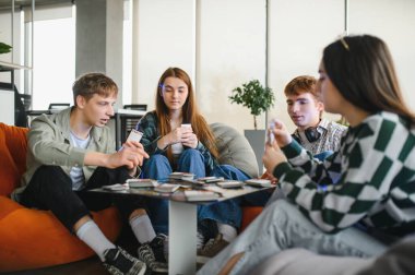 İş arkadaşları işe ara veriyor, ofis salonunda masa oyunu oynuyor, takım çalışmasını ve arkadaşlığı teşvik ediyor.