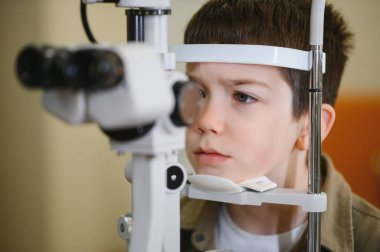 Görme kontrolünden geçen çocuk hasta göz bakımı ve teşhisinin sağlanması için göz hekimliği kliniğinde gelişmiş tıbbi ekipmanlarla tedavi görüyor.